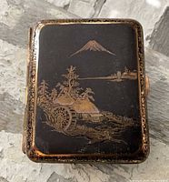 Front of cigarette case showing Mt. Fuji landscape damascene