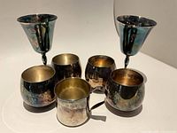 two goblets, four rounded tumblers, one handled cup