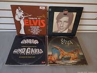 Four records: Tribute To Elvis, Leonard Cohen, Goddo Who Cares, Styx Equinox