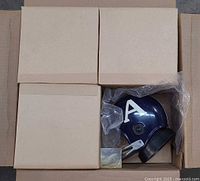 Open carton showing multiple boxed helmet radios, one partially visible