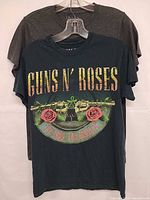 Front view showing both band T-shirts, Guns N' Roses in front, Queen behind