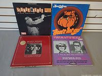 Front covers of four LPs: Sidney Bechet, Ben Sidran, Woody Herman, Jimmy & Marian McPartland