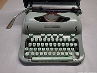 Front view of Hermes 3000 typewriter showing keyboard and carriage