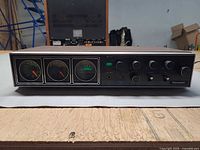 Front view showing silver face, knobs, meters, and branding