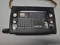 Front view of Nova-Tech Pilot II radio in leather case