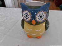 Front view of multicolor ceramic owl planter