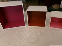 three cube shelves front view showing sizes and colored interiors