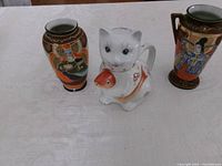 Full view of teapot and both vases on table