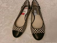Top view of both ballet flats showing houndstooth pattern and black cap toes