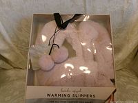 Front of boxed Nanette Lepore lavender warming slippers