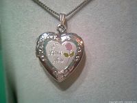 Closed heart locket showing I Love You inscription and rose