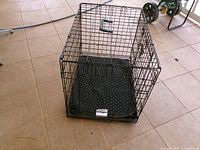 Overall view of wire crate with pad inside