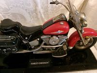 Right side view of red Harley-Davidson motorcycle telephone on base