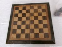 folded open wooden chess board showing 8x8 inlaid squares