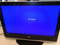 Front view of Vizio TV powered on displaying No Signal