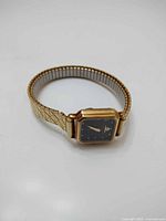 Full view of gold Baume & Mercier wristwatch with expansion bracelet