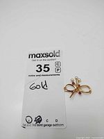 Full lot overview with MaxSold tag and brooch visible