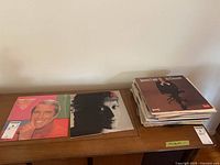 Front covers of Perry Como album, unidentified female vocalist album and visible stack of records