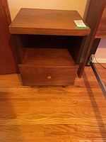 Front view of nightstand showing shelf and drawer