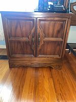 Front view of wooden nightstand cabinet showing double doors and overall appearance