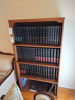 Front view of wood veneer bookcase with four shelves