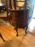 Front view of demilune cabinet showing drawers and legs