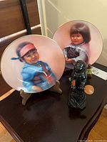 Group shot showing both plates on stands and stone figure