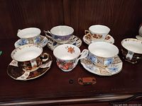 Overall lot view showing six teacups and four saucers