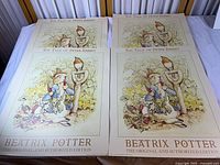 Four identical Peter Rabbit posters laid flat