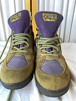 Front view of both boots showing laces, tongues, and logo patches