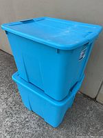 Two stacked blue Sterilite totes with lids