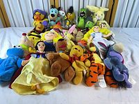 Group shot of all bean bag plush toys laid out on white surface