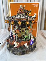 Full view of carousel with box backdrop, shows overall design and power cord