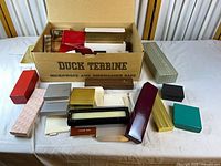 Overview of assorted empty presentation boxes inside and around a cardboard carton