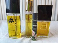 All four fragrance bottles front view showing labels and fill levels