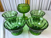 Full set showing one pedestal compote and four matching green bowls