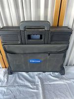 Crate folded flat with handle retracted, Precise logo visible