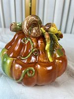 Oblique view of ceramic pumpkin dish with decorative lid