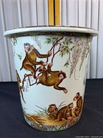 Full view of ceramic umbrella stand showing monkey scene