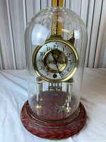 Full view of clock under dome on red base