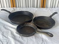 Three Wagner's 1891 Original cast iron skillets different sizes