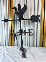 Full view of weather vane showing duck finial, arrow, directionals, mast, and mount