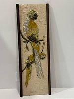 Full view of gravel art panel showing two parrots and frame