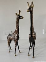 Front view of both brass giraffe figurines