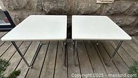 Two square white top tables front view