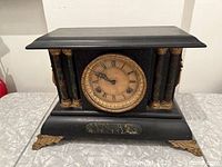 Front view showing dial, columns and feet