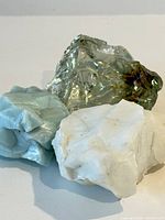 All three slag glass chunks grouped together showing color and texture