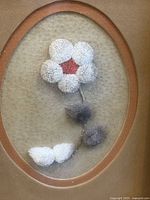 Full view of framed hair-tufting artwork