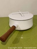 Saucepan with lid on, showing exterior and handle