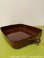 Angled top view showing brown enamel finish and handle design